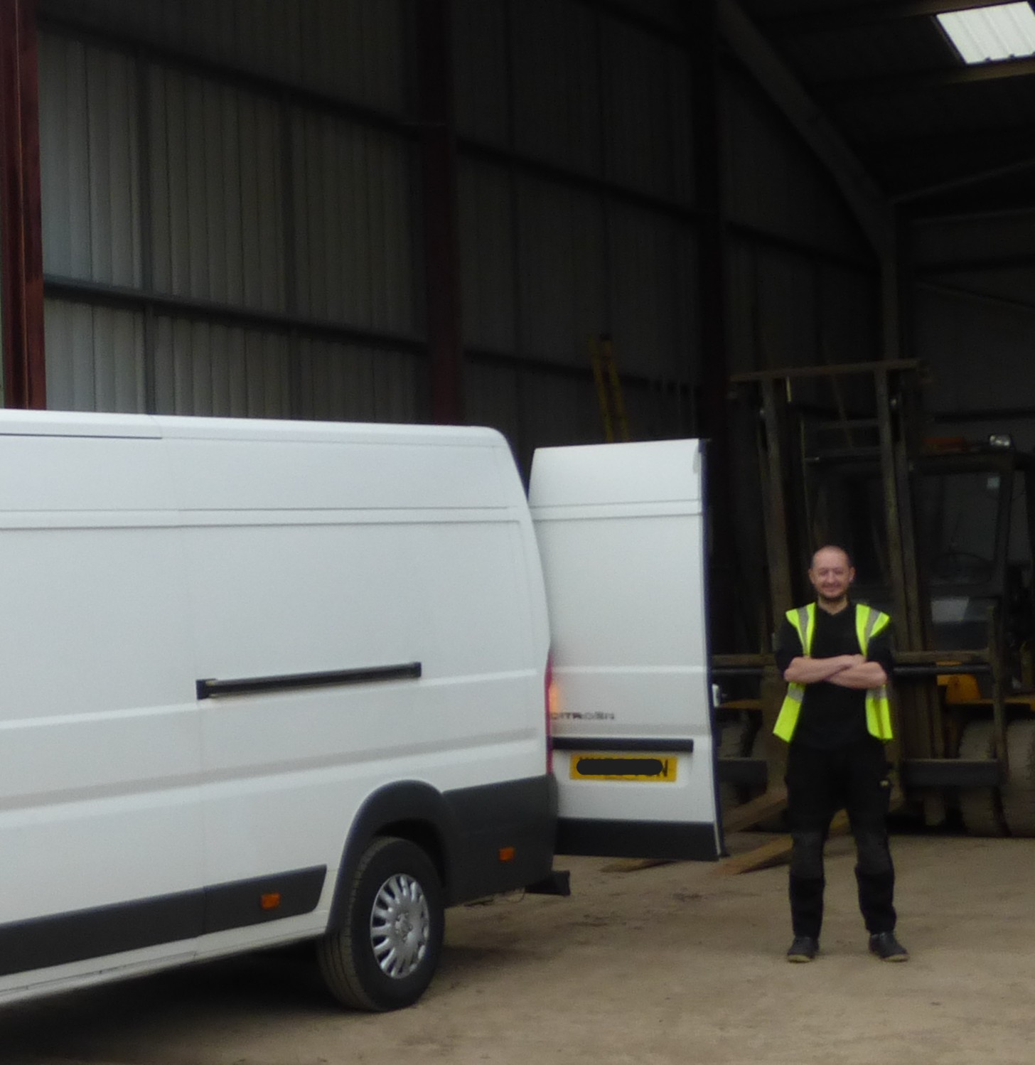 Stuart from Avango Couriers standing by a delivery van